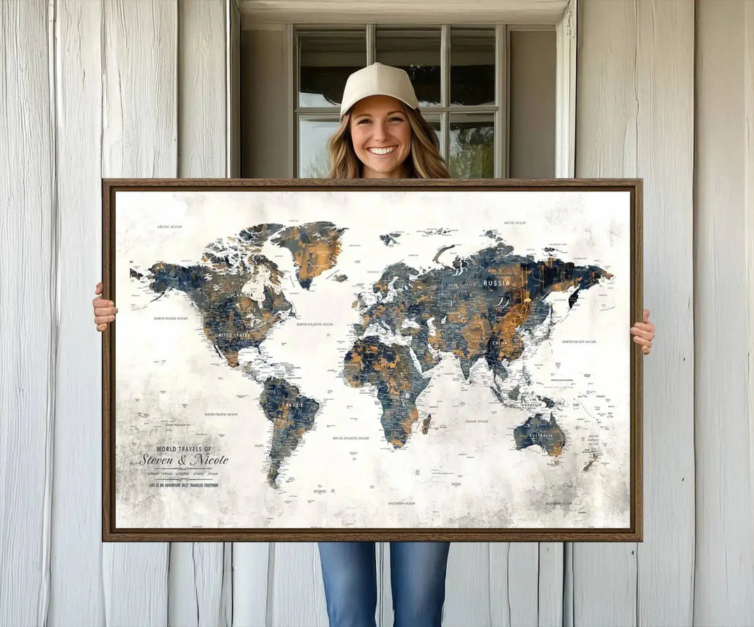 A smiling woman proudly holds the Personalized Push Pin Map Wall Art Print - Detailed Custom World Map Canvas Print in front of a white wall, perfect for travel enthusiasts eager to mark their adventures.