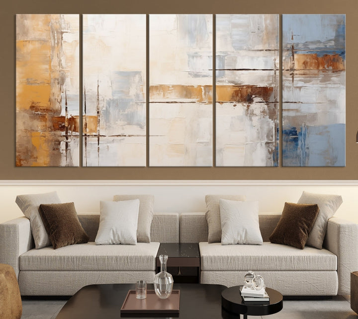 The Pastel Abstract Multi Panel Wall Art Canvas Print, featuring blue, white, and brown tones on museum-quality canvas, is ready to hang and includes a UV-protective coating for enduring vibrancy.